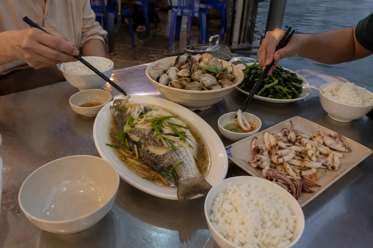 A shared Ha Long seafood meal with steamed shellfish fish vegetables and rice
