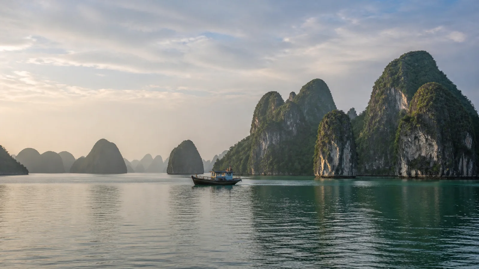 Limestone islands rising through mist over Ha Long Bay